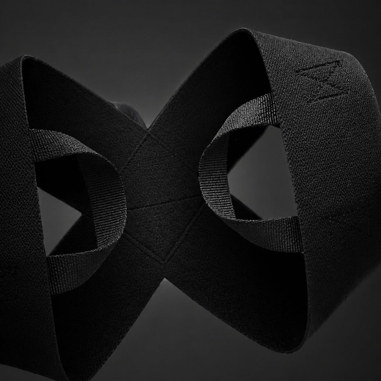 Black textured resistance band with interlocking design for fitness training